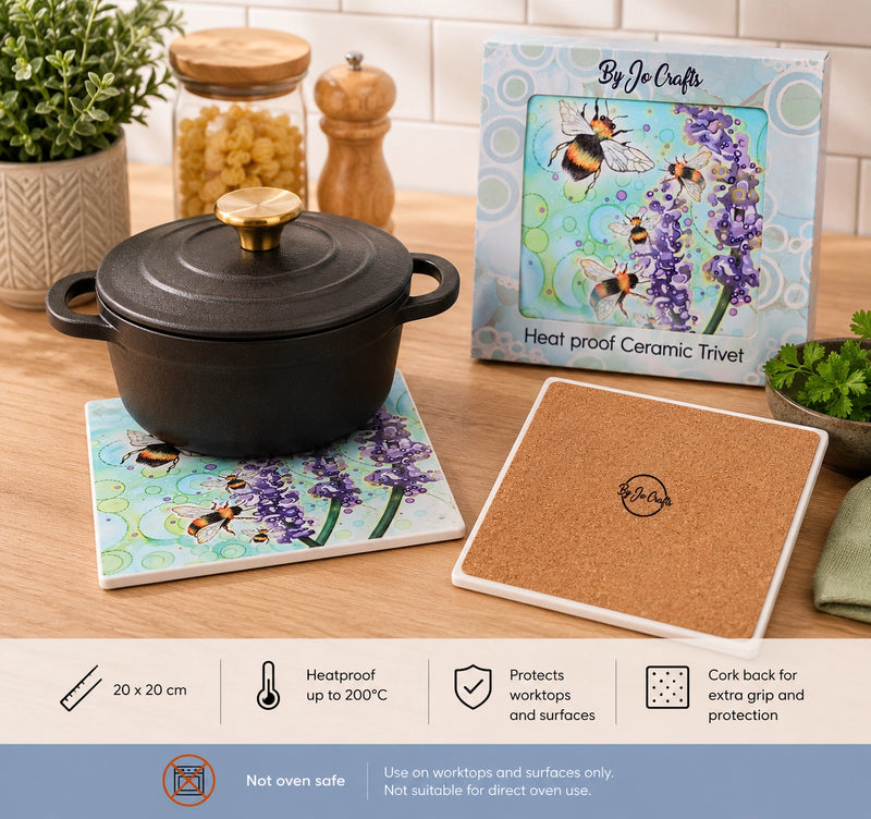 Bumblebee and Lavender ceramic trivet with cast iron casserole dish on wooden kitchen worktop, shown with gift box and cork backing