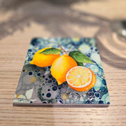 Lemon ceramic coaster flat lay on wooden surface showing full lemon design from above