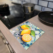 Lemon ceramic trivet in use on wooden kitchen worktop beside hob with saucepan