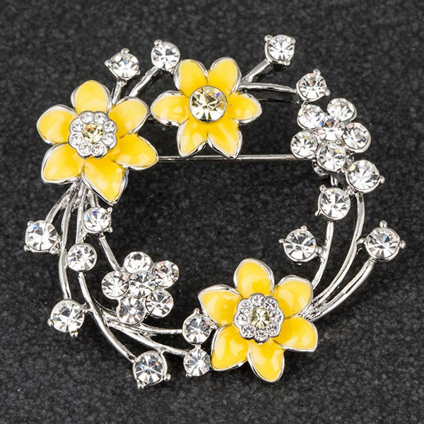 Equilibrium Radiant Daffodil Round Brooch with yellow daffodil flowers and crystal-effect stones on dark background