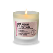 Henry & Co Rose Jasmine and Ylang Ylang scented candle 30cl lit in a frosted glass vessel with bamboo lid on a white background