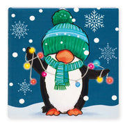 Ceramic Christmas coaster featuring a penguin in a bobble hat and scarf holding a string of fairy lights, surrounded by snowflakes.