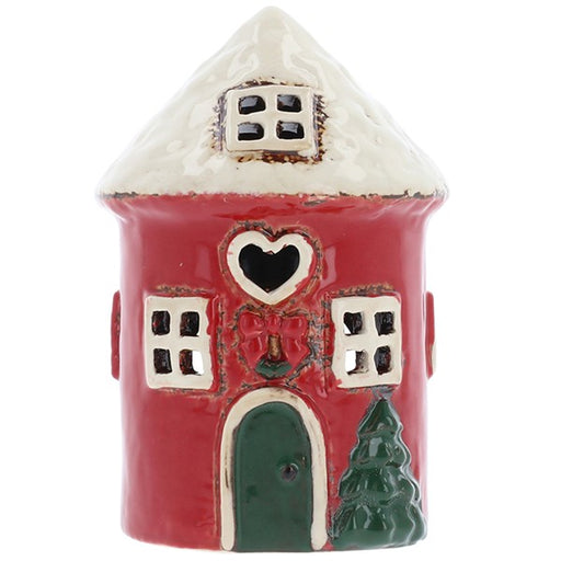 Village Pottery rustic Christmas round red house tealight holder with white roof, heart-shaped cutout, green arched door, holly and bow decoration and a small Christmas tree