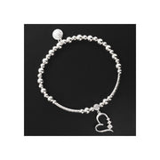 Equilibrium Open Heart Crystal Silver Plated Stretch Bracelet with silver plated ball beads, bar sections, open heart charm with crystal-effect stone at the bail and three graduating crystal-effect stones along the side, and Equilibrium disc charm, on black background