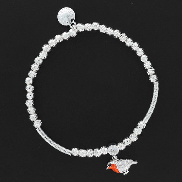 Equilibrium Robins Appear silver-plated beaded stretch bracelet with a robin charm and Cubic Zirconia connector on a dark background