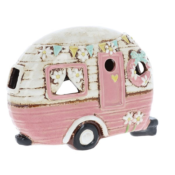 Village Pottery pink ceramic caravan tea light holder decorated with colourful bunting, a floral wreath, heart door detail and daisy trim, with cut-out windows