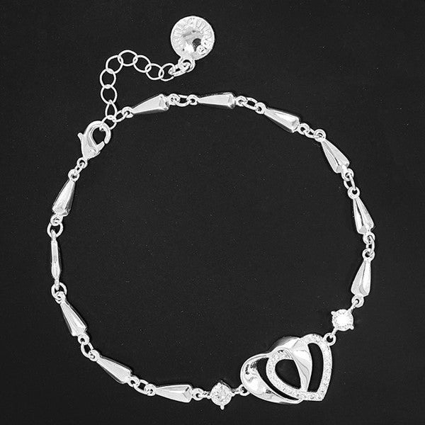 Equilibrium Te Amo Entwined Hearts Silver Plated Bracelet on dark background showing teardrop-link chain and interlocking heart detail