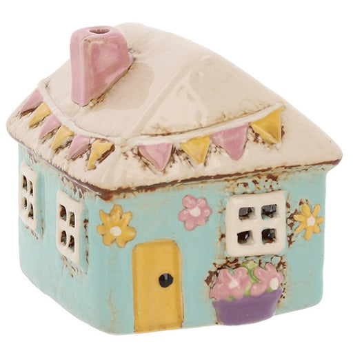 Village Pottery Garden Mini House ceramic tealight holder with pastel blue walls, cream roof, pink chimney, colourful bunting and floral details