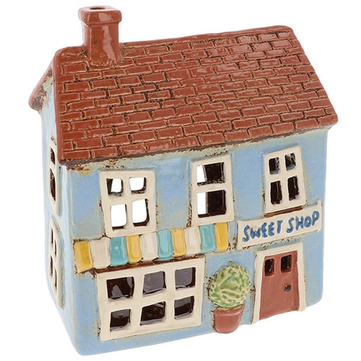 Village Pottery Sweet Shop ceramic tealight holder with light blue exterior, striped awning and pot plant by the door, front view on white background