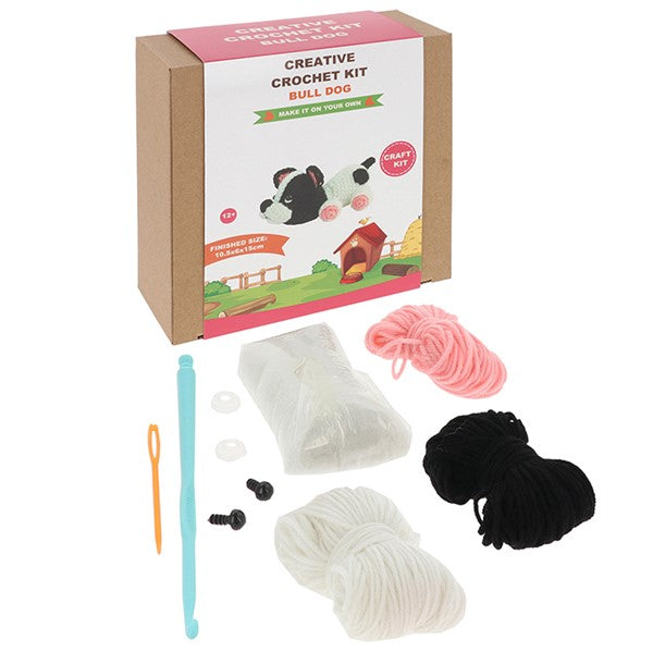 Contents of the Creative Crochet French Bulldog kit showing yarn, hook, stuffing and instructions