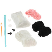 Contents of the Creative Crochet French Bulldog kit showing yarn, hook, stuffing and instructions