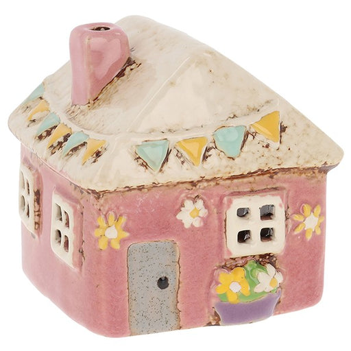 Handcrafted ceramic pink garden house mini tealight holder with cream roof, pink chimney, decorative bunting and floral details, on a white background