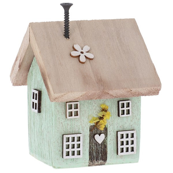 Spring Folk Art Cottage House ornament in green pastel with flower and heart cut-out detail