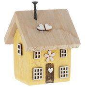 Spring Folk Art Cottage House ornament in yellow pastel with flower and heart cut-out detail