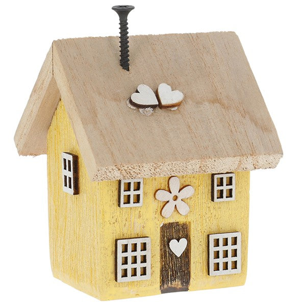 Spring Folk Art Cottage House ornament in yellow pastel with flower and heart cut-out detail