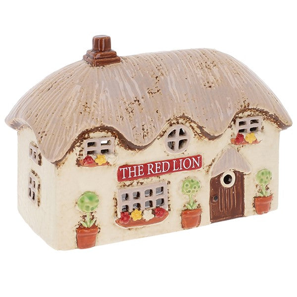 Handcrafted ceramic Red Lion pub tealight holder with thatched roof, window boxes and pot plants, from Shudehill Village Pottery Cottage Collection