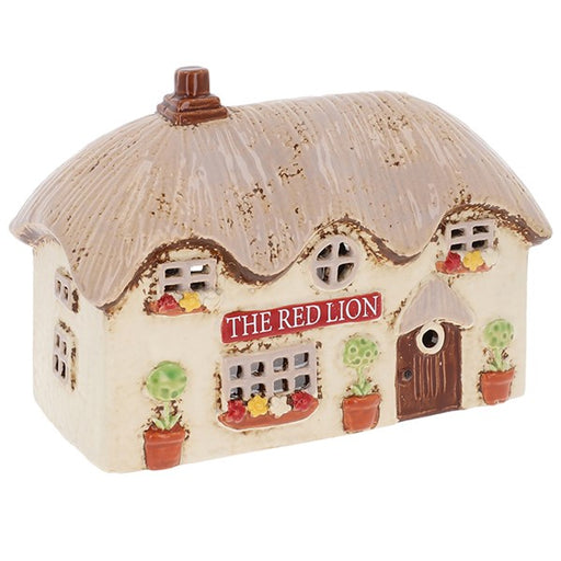 Handcrafted ceramic Red Lion pub tealight holder with thatched roof, window boxes and pot plants, from Shudehill Village Pottery Cottage Collection