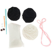 Contents of the Creative Crochet Black and White Cat kit showing yarn, hook, stuffing and instructions