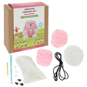 Contents of the Creative Crochet Pink Bunny kit showing pink yarn, hook, stuffing and instructions

