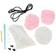 Contents of the Creative Crochet Pink Bunny kit showing pink yarn, hook, stuffing and instructions

