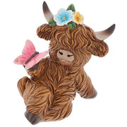 Garden Bloom Highland Cow ornament with floral crown and pink butterfly, on a white background