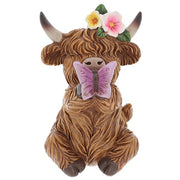 Garden Bloom Highland Cow ornament with floral crown and purple butterfly, on a white background