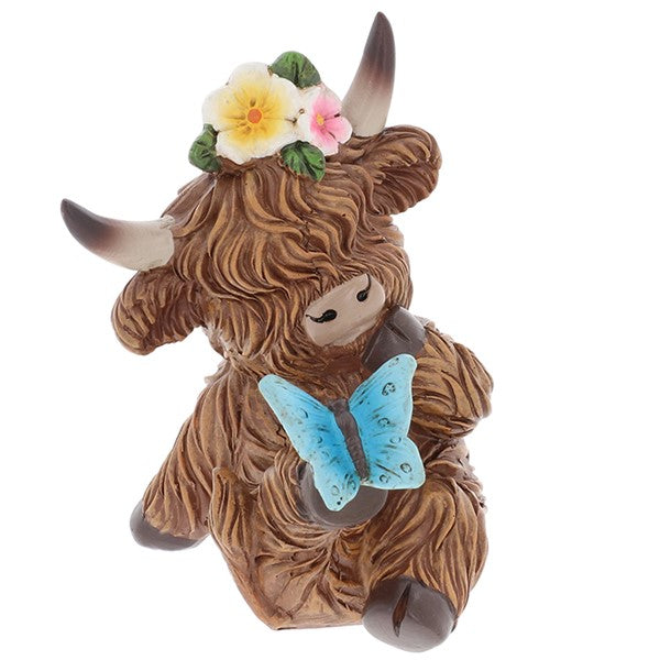 Garden Bloom Highland Cow ornament with floral crown and blue butterfly, on a white background