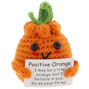 Cheery Crochet Positive Orange, handmade crochet fruit character, presented on a white background