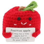 Cheery Crochet Positive Apple, handmade crochet fruit character, presented on a white background