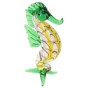 Glass seahorse figurine in green, presented on a white background
