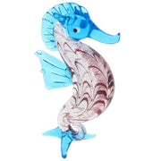 Glass seahorse figurine in blue, presented on a white background