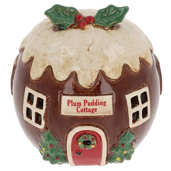 Village Pottery Plum Pudding Cottage tealight house, round brown building with cream sauce drip roof, holly and berry topping, red arched door with wreath and holly bushes, white background