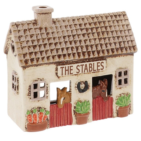 Village Pottery The Stables ceramic tealight holder with two ponies peering over stable doors, horseshoe on wall and carrots outside, front view on white background