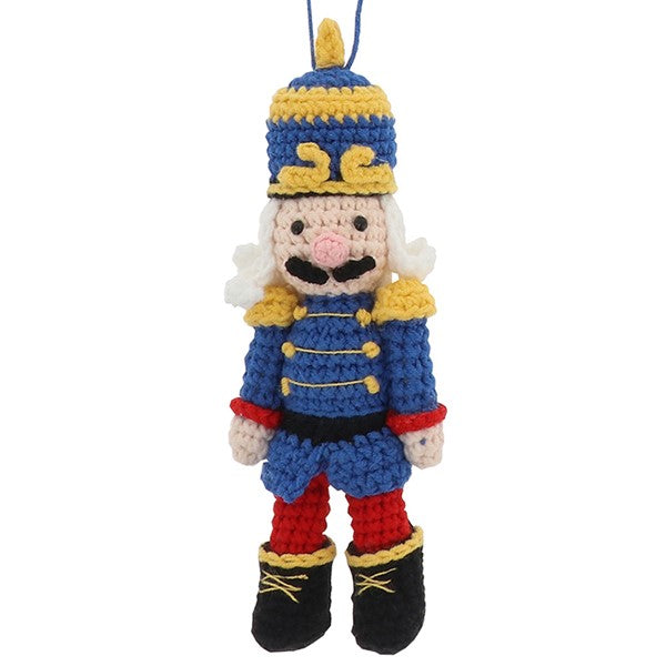 Knitted nutcracker hanging decoration in blue uniform with gold trim, plumed hat and black boots