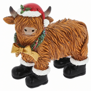 Merry Christmas Coos in Boots highland cow figurine wearing a red Santa hat with holly, holly wreath with gold bow, and black boots with white fluffy trim