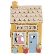 Village Pottery Boutique ceramic tea light holder, buttercup yellow exterior with scalloped cream tiled roof and yellow chimney, front view
