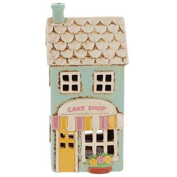 Village Pottery ceramic cake shop tea light holder, duck egg blue two-storey building with scalloped cream roof, yellow door, pink and yellow striped awning and Cake Shop signage