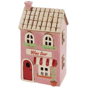 Side view of Village Pottery wine bar tea light holder showing pink exterior and tiled roof detail