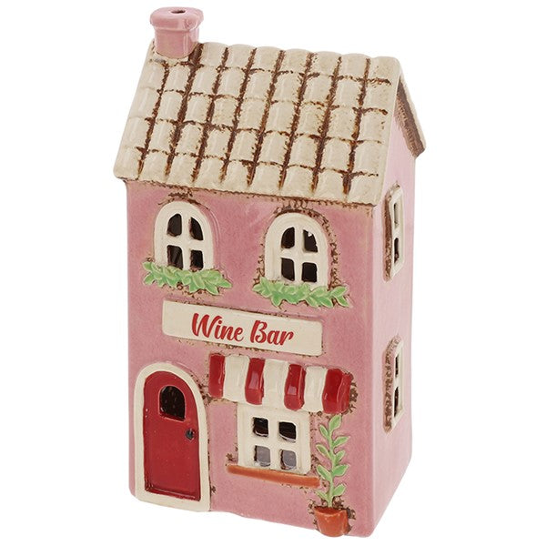 Side view of Village Pottery wine bar tea light holder showing pink exterior and tiled roof detail