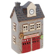 Three-quarter view of Village Pottery fire station tea light holder showing full building detail, red garage doors and Fire Station signage