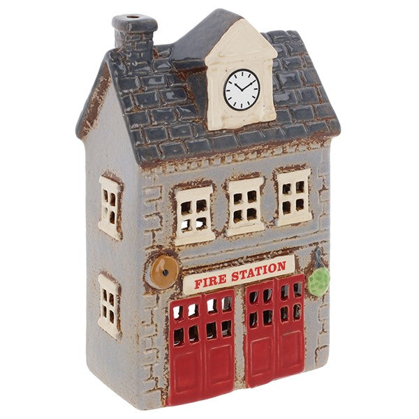 Three-quarter view of Village Pottery fire station tea light holder showing full building detail, red garage doors and Fire Station signage