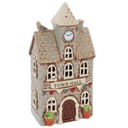 Angled view of Village Pottery town hall tea light holder showing clock tower, small bird detail, chimney and arched windows