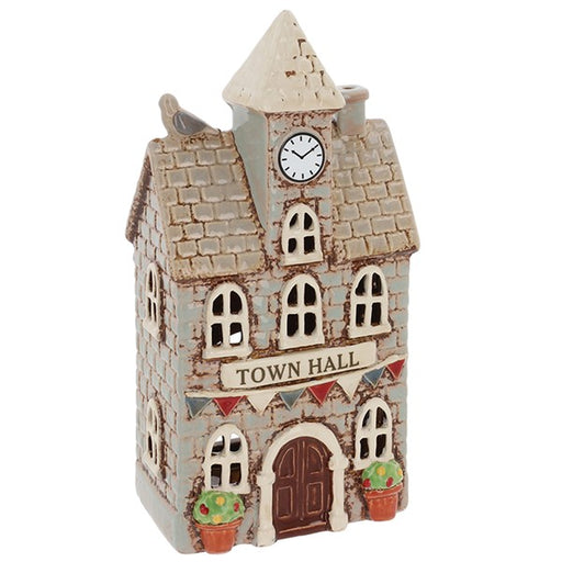 Angled view of Village Pottery town hall tea light holder showing clock tower, small bird detail, chimney and arched windows