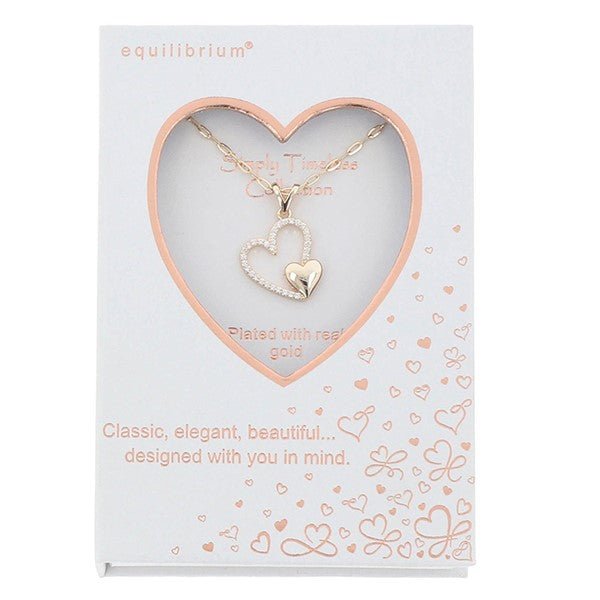 Equilibrium Heart Duo necklace displayed in a Simply Timeless Collection presentation box.