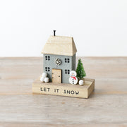 Quirky wooden Let It Snow house decoration with snowflake details, smiling snowman with red scarf, snow-dusted bottle brush tree and white snowball clusters, 12cm
