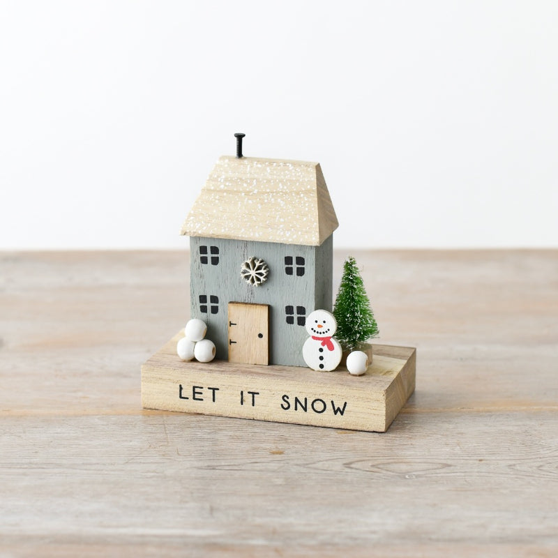Quirky wooden Let It Snow house decoration with snowflake details, smiling snowman with red scarf, snow-dusted bottle brush tree and white snowball clusters, 12cm