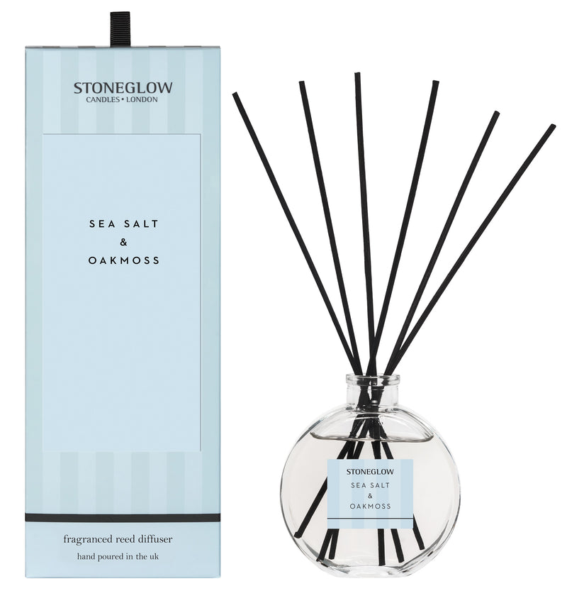 Stoneglow Modern Classics Sea Salt and Oakmoss Reed Diffuser in globe glass vessel with black reeds, shown with pale blue gift box