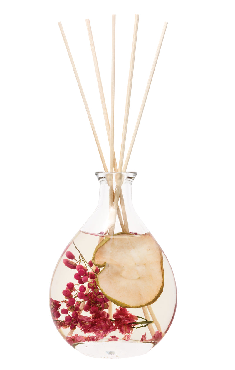 Stoneglow Nature's Gift Apple and Pear Blossom Reed Diffuser in teardrop glass vessel with dried botanicals and fruit slices