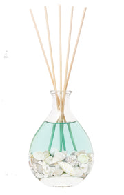 Stoneglow Nature's Gift Ocean Reed Diffuser close-up showing rounded glass vessel filled with seashells and rattan reeds