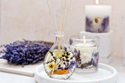Stoneglow Nature's Gift Lilac and Lavender reed diffuser and botanical candle styled together on marble tray with dried florals